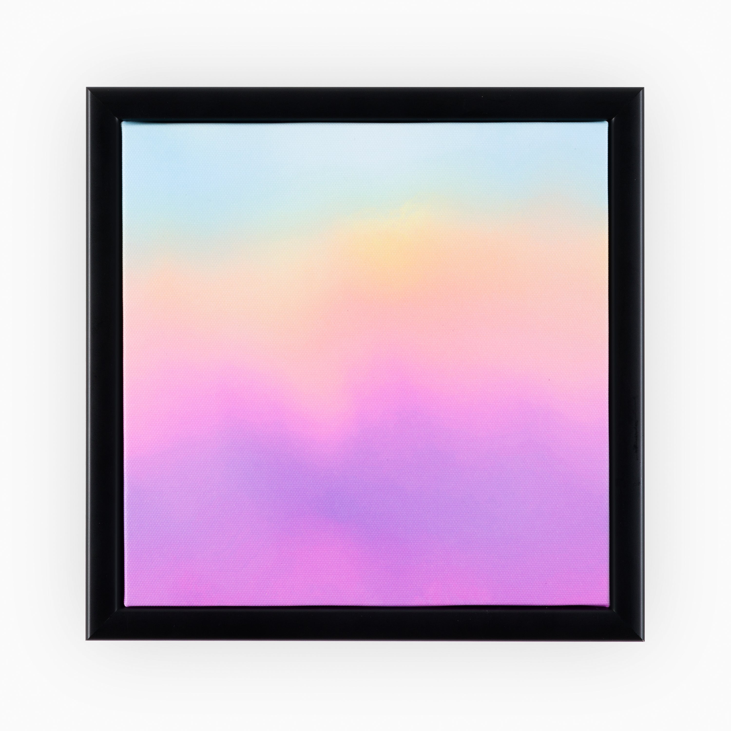 Luxury abstract canvas artwork in a sleek black frame, featuring a soft blended gradient of pastel pink, purple, yellow and blue hues.