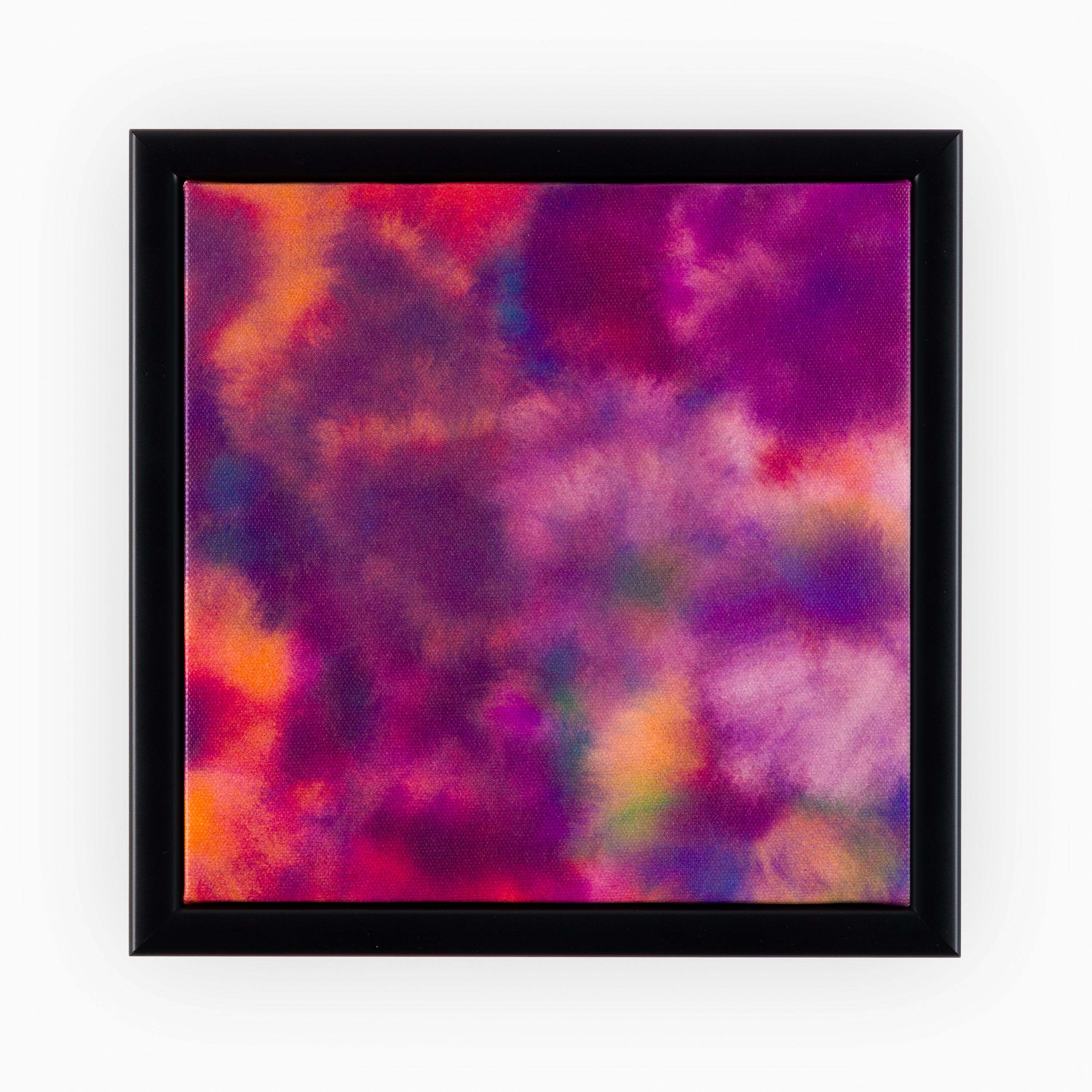 Framed Canvas in a sleek black frame, displaying a vibrant abstract mélange of deep purples, fiery oranges, and crimson hues, ideal for sophisticated interior décor. 