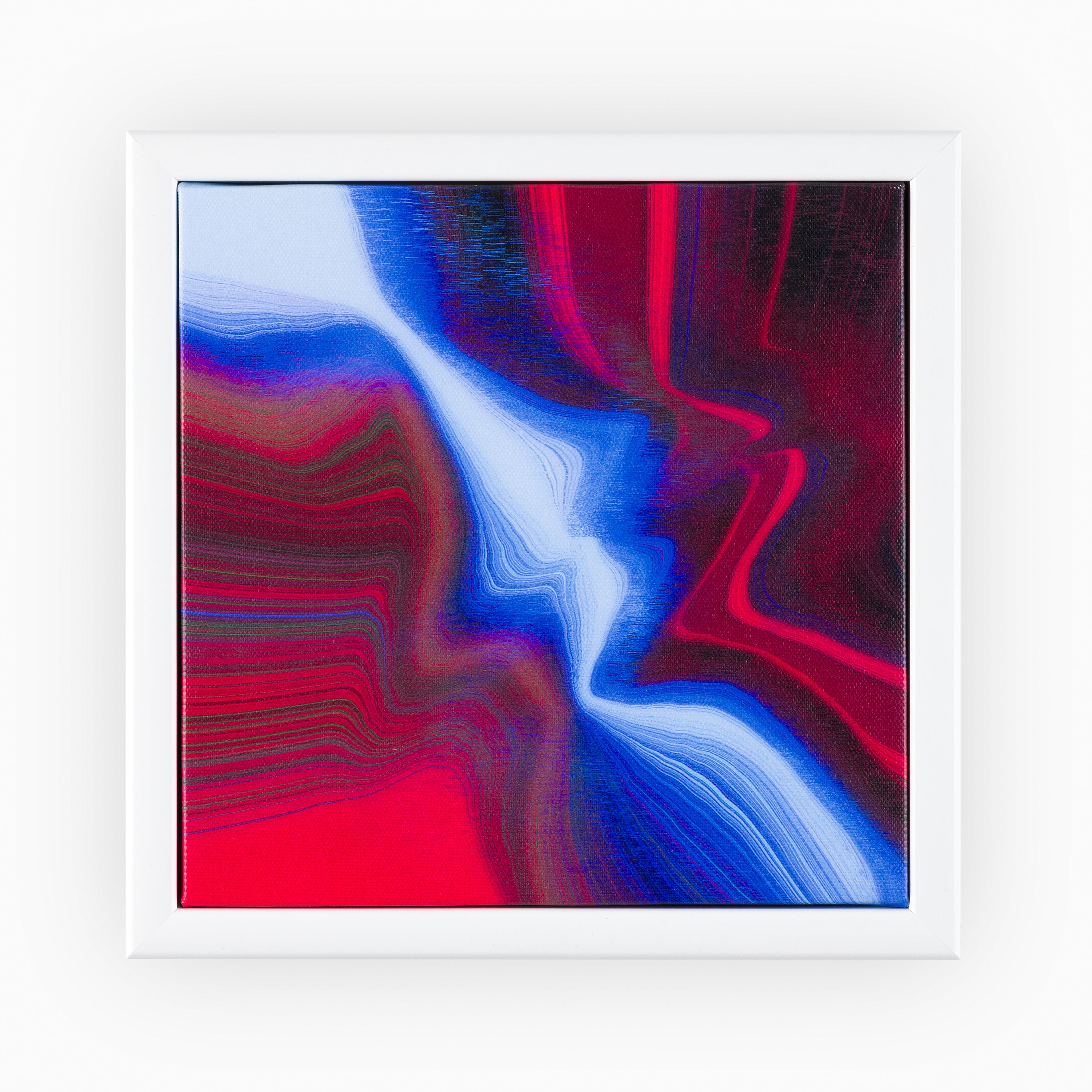 Striking abstract canvas artwork with undulating shades of crimson and sapphire, evoking the ebbs and flows of an ocean, showcased in a sleek white frame.