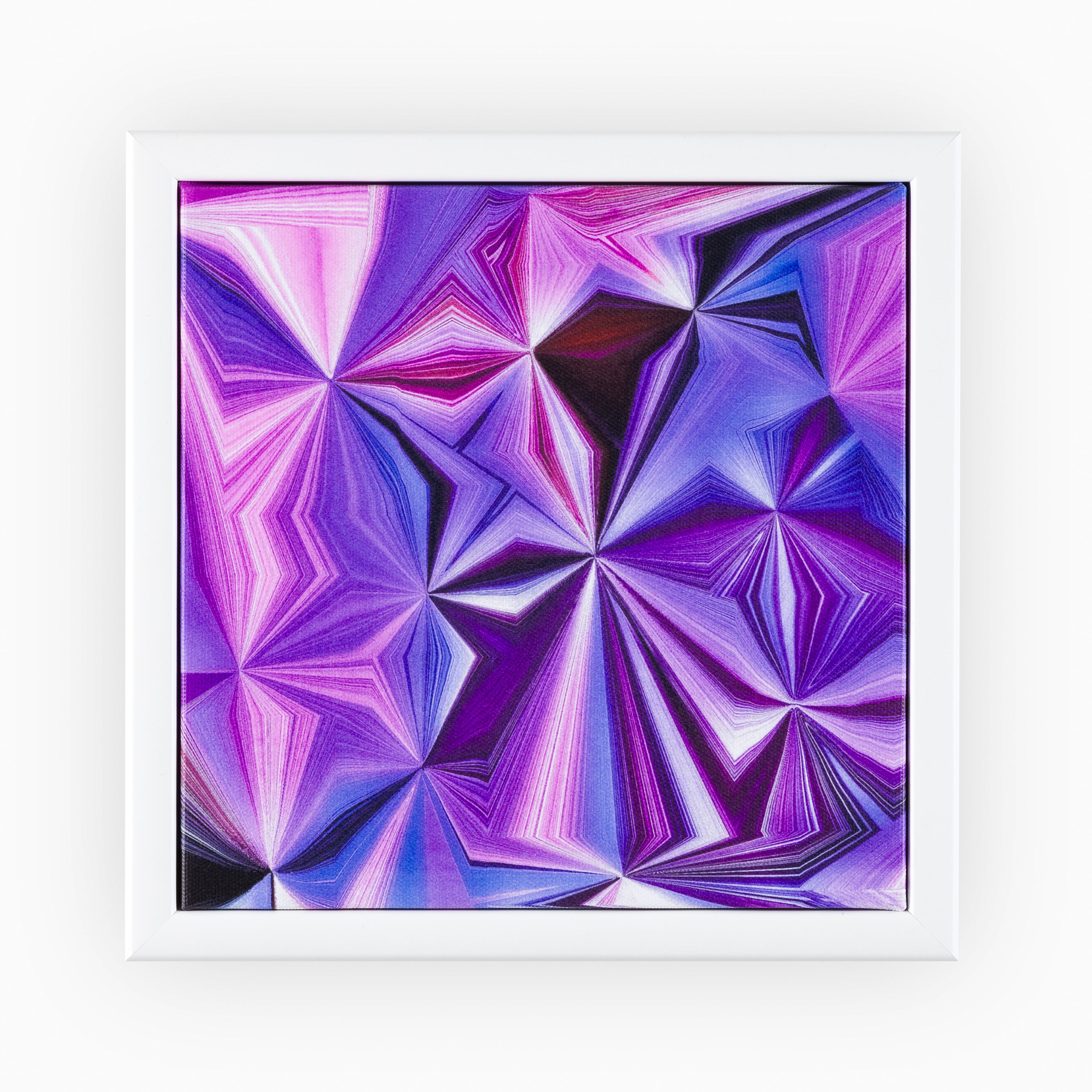 Elegant canvas art piece presenting a geometric pattern resembling gemstone facets in a spectrum of purples and pinks, beautifully complemented by a classic white frame.